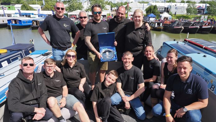 The Bespoke Boat Company team with the trophy for Favourite Widebeam at Crick Boat Show 2024 on the roof deck of their winning boat Lunar. Photo courtesy Crick Boat Show