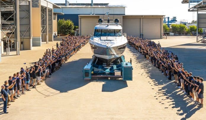 The Riviera team celebrate the launch of their 6000th motor yacht